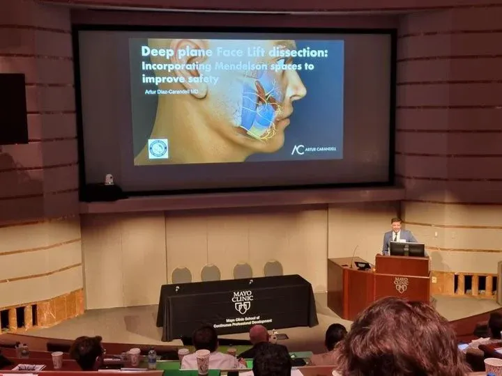 Dr. Artur Carandell lecturing on deep plane facelift techniques.