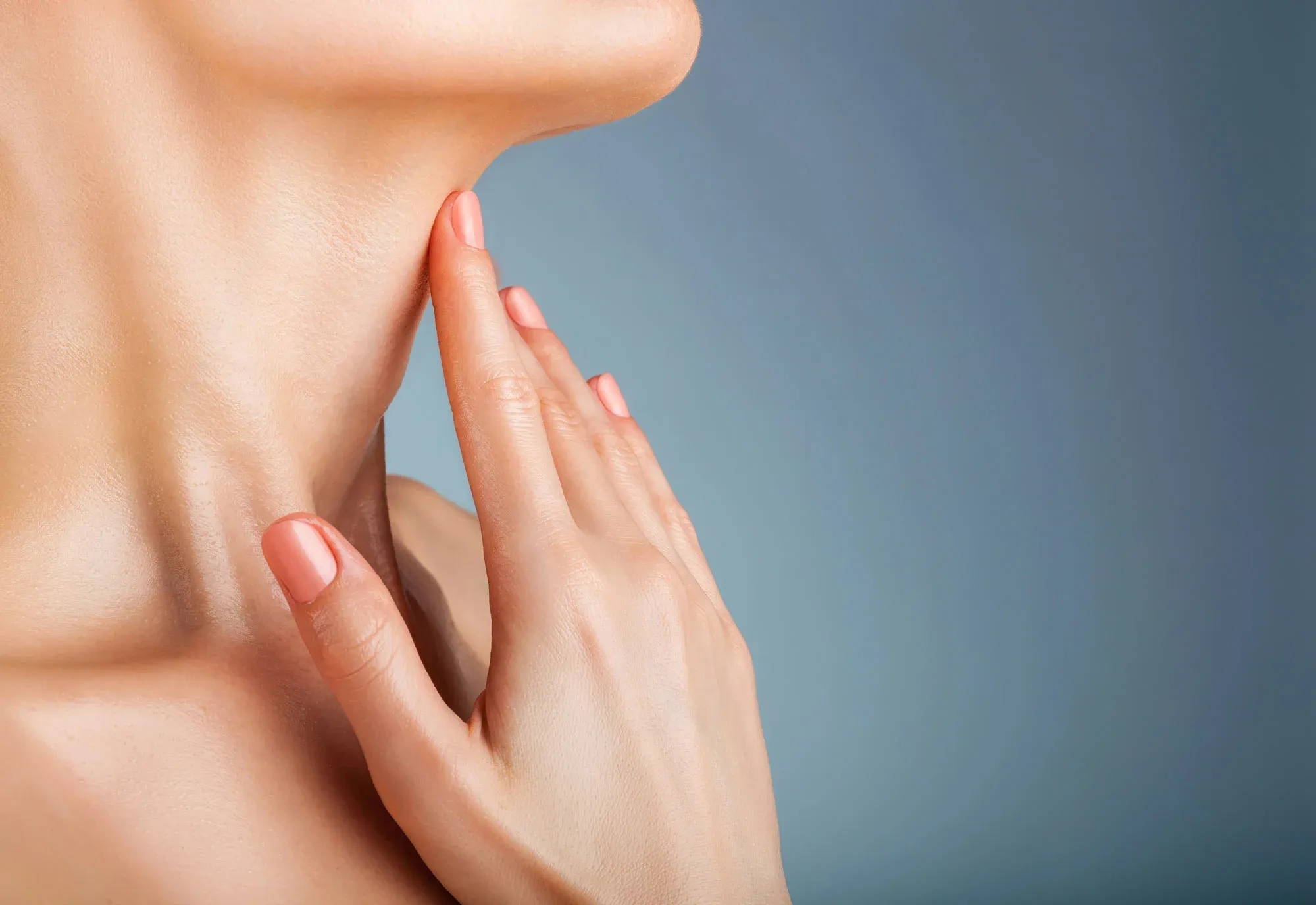 Close-up of hand touching neck skin care