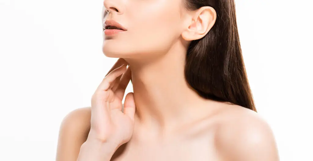 Woman with smooth skin touching neck